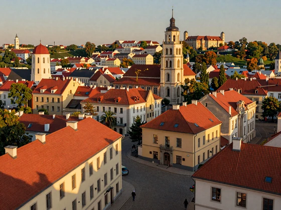 Scenic Vilnius Old Town skyline with baroque church spires and red rooftops bathed in golden sunset light